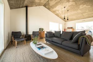 a living room with a couch and a table at Casa do Roxo - Eco Design Country House in Santa Vitória
