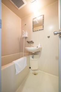 a bathroom with a sink and a toilet and a mirror at maison elegance - Vacation STAY 15799 in Tokyo