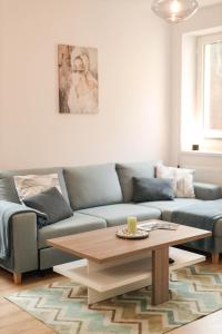 a living room with a couch and a coffee table at Apartmán NeKLID in Jáchymov