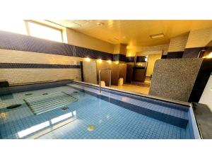 a large swimming pool in a large room at Green Rich Hotel Naha - Vacation STAY 59243v in Naha