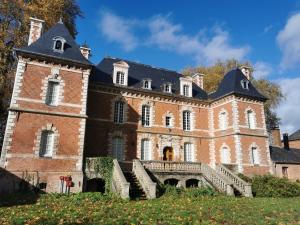 a large brick building with a staircase in front of it at Domaine de Penthièvre in Blangy-sur-Bresle