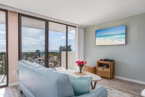 a living room with a couch and a table at Our House At The Beach, East Tower, 5th Fl in Siesta Key