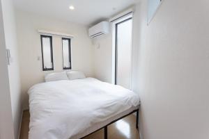 Кровать или кровати в номере Shinjuku City House - Vacation STAY 15772