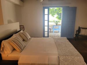 um quarto com uma cama grande e uma porta para um quintal em casa lumka hotel boutique spa em Mariquita