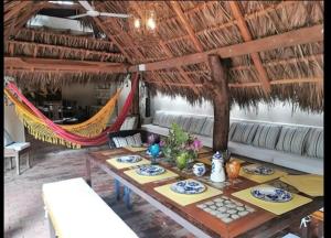a dining room with a table and a hammock at casa lumka hotel boutique spa in Mariquita