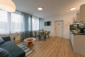 a living room with a couch and a table at 2-Zimmer Themen-Apartment im Zentrum, Nähe Oper in Bayreuth +24 photos