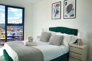 a bedroom with a large bed with a teddy bear on it at AP- Luxury Apt nxt to o2 Academy in Birmingham