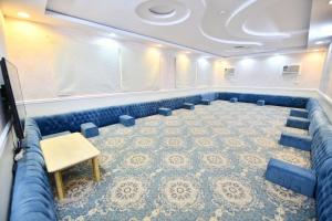 a conference room with blue chairs and a table at شاليه ليالي in AlUla