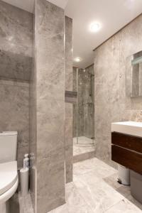 a bathroom with a toilet sink and a shower at THE PAD at Sloane Square in London