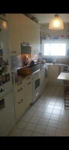 a kitchen with a sink and a stove top oven at Room cosycosy in Clichy