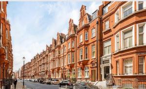 a row of brick buildings on a city street at THE PAD at Sloane Square in London