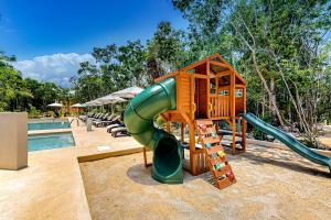 a playground with a slide next to a pool at TAO Edena 68 in Tulum
