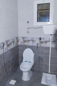 a bathroom with a toilet and a sink at شاليه ليالي in AlUla