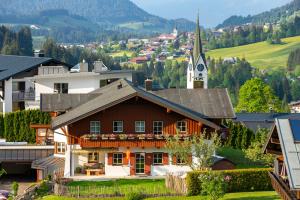 ein Haus in einem Dorf mit einer Kirche in der Unterkunft Haus Berg & Tal in Hirschegg