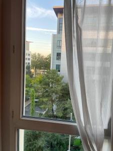 a window with a view of a city at Room cosycosy in Clichy
