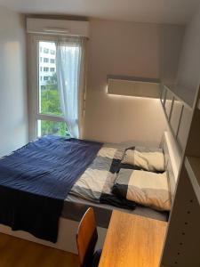 a bed in a bedroom with a window at Room cosycosy in Clichy