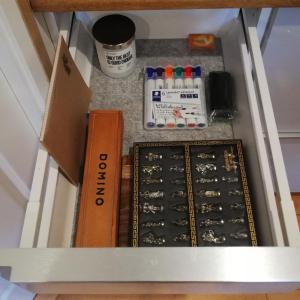a drawer with a box and other items on a table at Tæt på Langesø in Morud