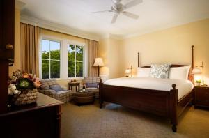 a bedroom with a large bed and a living room at Montage Palmetto Bluff in Bluffton
