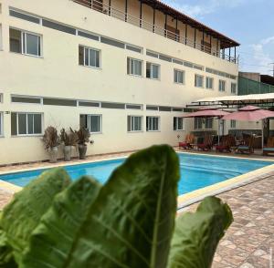 a close up of a leaf next to a swimming pool at Locanda Inn Place in Luanda