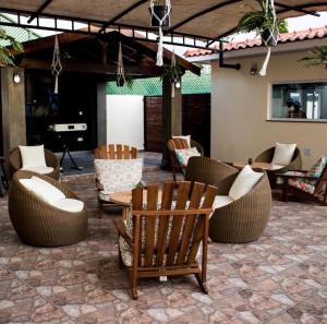 a patio with couches and chairs and a table at Locanda Inn Place in Luanda