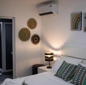 a bedroom with a bed and a lamp on a wall at Locanda Inn Place in Luanda