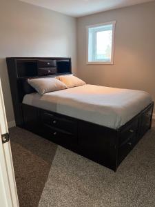 a bedroom with a large bed with a large headboard at Entire Guest suite & Vacation home in Whitehorse in Whitehorse