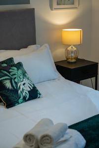 a bedroom with a bed with a lamp on a table at Stylish LUXE 4Beds Abbey Rd St Johns Wood in London