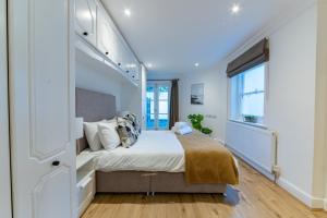 a bedroom with a large bed and a window at 4 Bedrooms Peaceful Home Abbey Rd - St Johns Wood in London