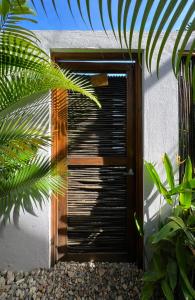 a wooden door with a shutter on the side of a building at La Floristería in Palomino