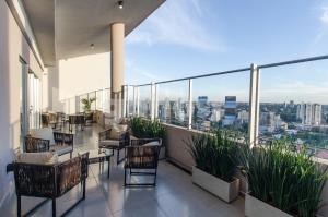 a balcony with chairs and a view of the city at Brand New Apartment In Las Lomas Neighborhood in Asunción