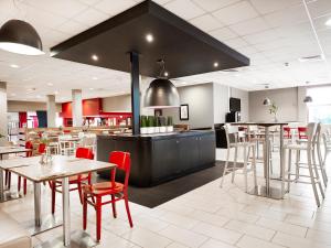 a restaurant with tables and chairs and a stove at Campanile Swindon in Swindon