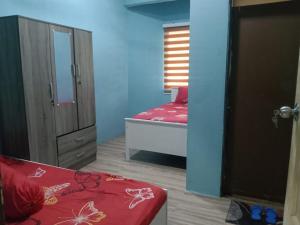Habitación con dormitorio con cama y espejo. en Nur Aisyah homestay, en Kampong Kemaman
