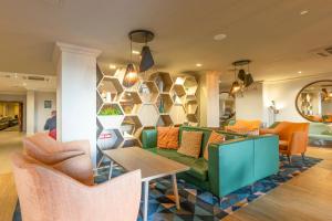 a living room with a green couch and chairs at Holiday Inn - Glasgow Airport by IHG in Paisley