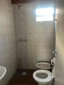 a bathroom with a toilet and a sink at Depto céntrico General Alvear in General Alvear