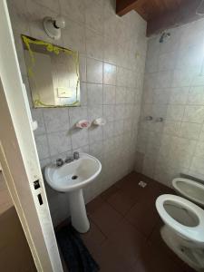 a bathroom with a sink and a toilet at Depto céntrico General Alvear in General Alvear