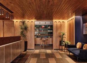 a lobby with wood paneling and a table and chairs at Romer Hell's Kitchen in New York