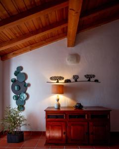 a room with a table and a lamp on a wall at Vespa House in Igrejinha