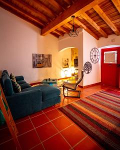 a living room with a blue couch and a red door at Vespa House in Igrejinha