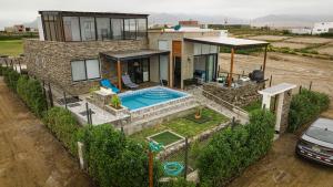 a house with a swimming pool in front of it at Mar y campo Casa Huarca in La Isla