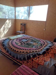 a bedroom with a bed with a design on it at Maison Nim in Máncora