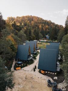 an overhead view of a row of houses with blue roofs at Campulung Chalets in Bughea de Sus