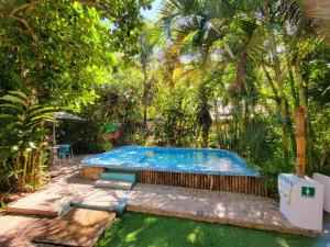 a swimming pool in a yard with trees at River Front Casa Antahkarana Nogalito Hotel Room 6 in Puerto Vallarta