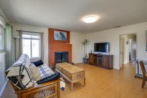 a living room with a couch and a fireplace at Pet-Friendly Home about 5 Mi to Knotts Berry Farm! in Lakewood