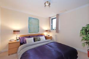 a bedroom with a large purple bed and a window at Great City Centre Apartment in Aberdeen Scotland in Aberdeen