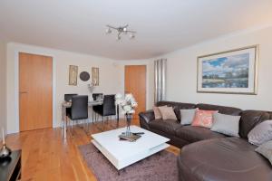 a living room with a couch and a table at Great City Centre Apartment in Aberdeen Scotland in Aberdeen