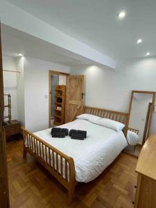 a bedroom with a bed with two black bags on it at One bedroom Countryside Annexe in Boars Hill