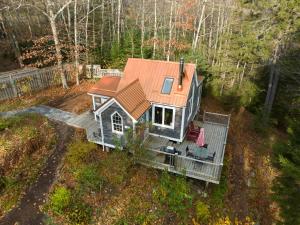 an aerial view of a tiny house in the woods at Quiet Riverside Retreat with 2 Fireplaces in Petite Rivière Bridge