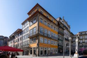 a large yellow building on a city street at LÓIOS 74 by DA'HOME in Porto