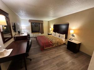 a hotel room with a bed and a desk at Econo Lodge Scranton near Montage Mountain in Scranton