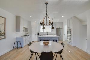 a white kitchen with a table and chairs at Modern Downtown Provo Townhome with Balcony! in Provo